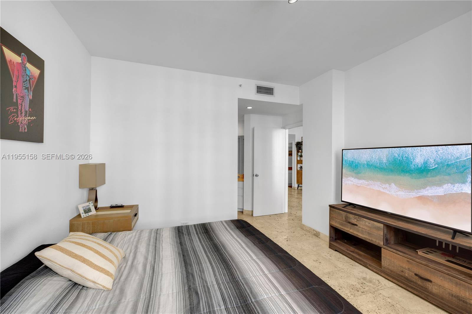 888 Brickell Key Drive, Unit 701 Miami, FL 33131 - Photo 19 of 20 a bedroom with bed and flat screen tv