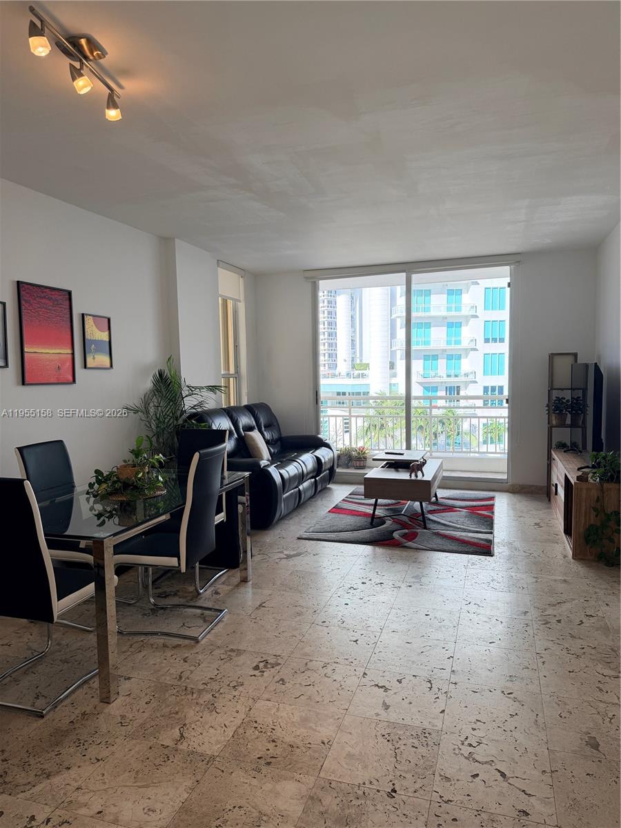 888 Brickell Key Drive, Unit 701 Miami, FL 33131 - Photo 20 of 20 a living room with furniture and a flat screen tv