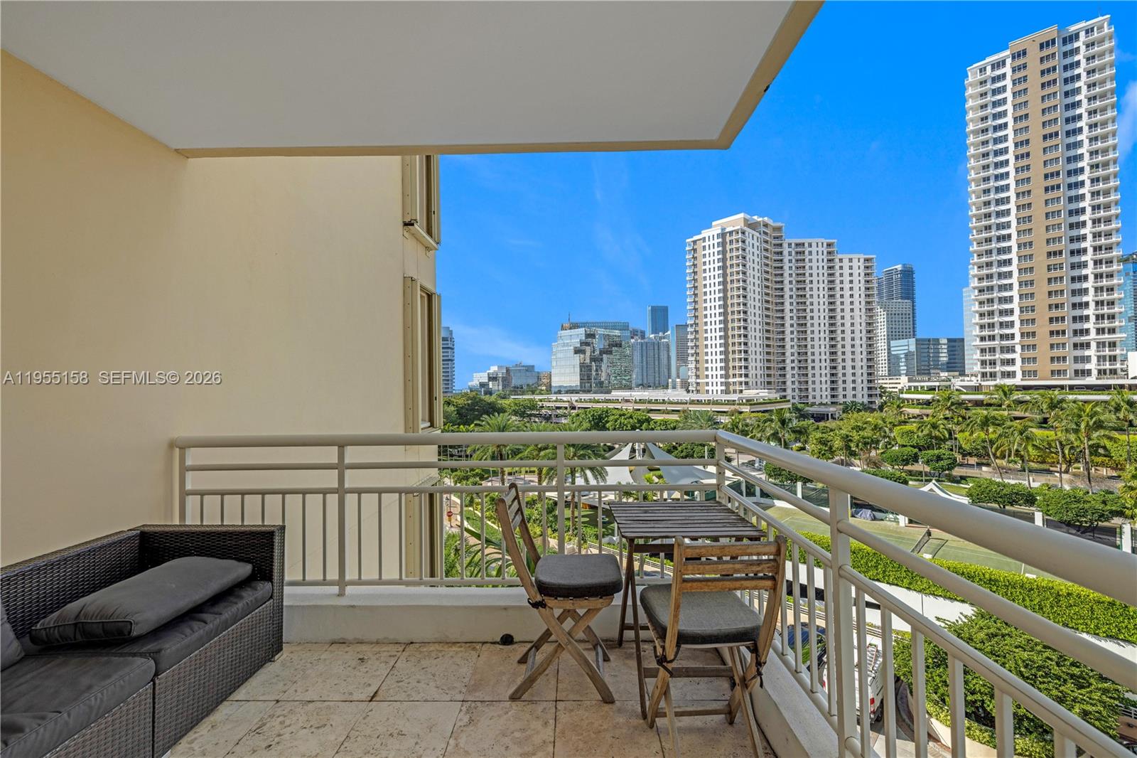 888 Brickell Key Drive, Unit 701 Miami, FL 33131 - Photo 4 of 20 a balcony with table and chairs