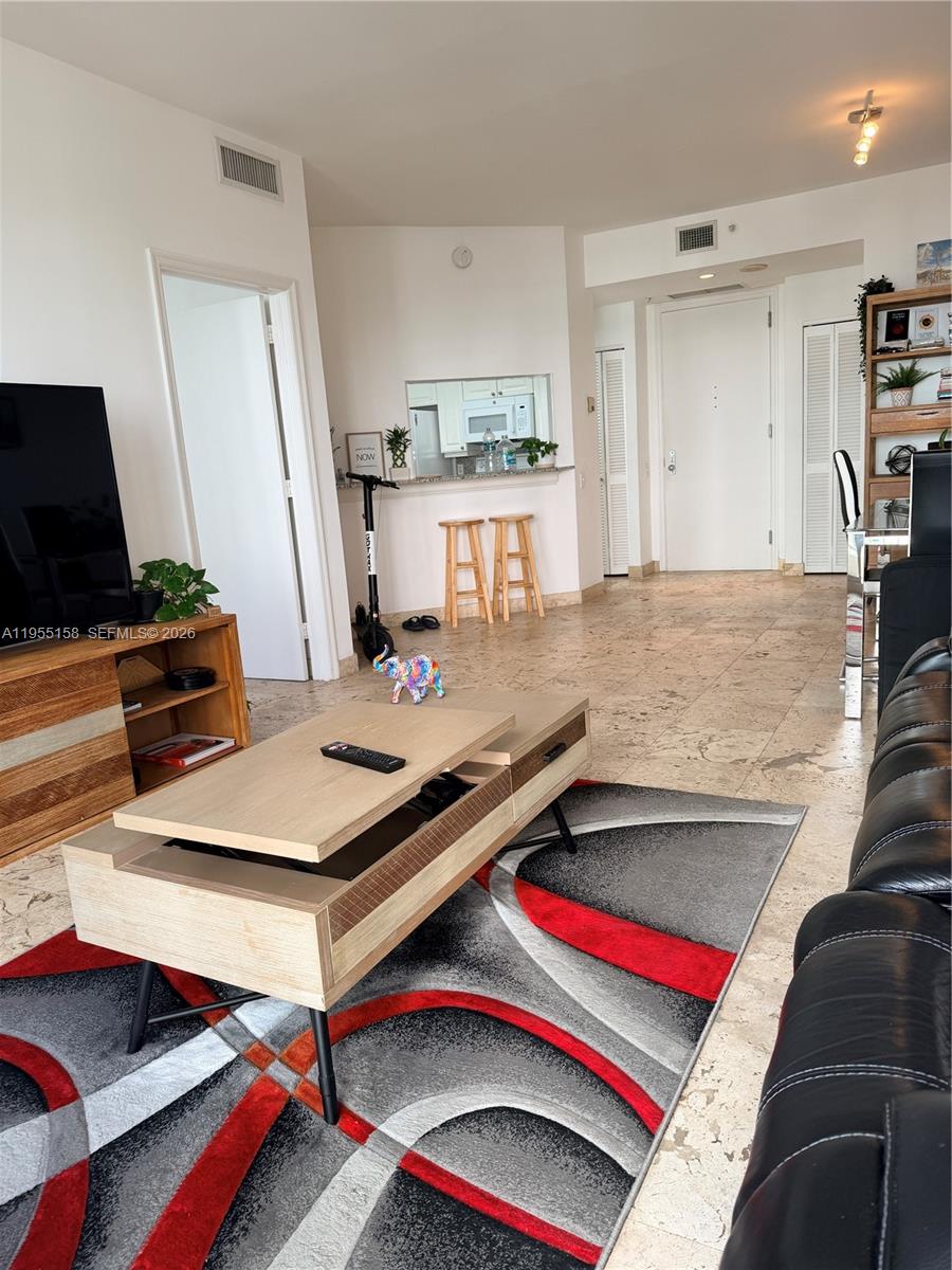 888 Brickell Key Drive, Unit 701 Miami, FL 33131 - Photo 6 of 20 a room with furniture and a table