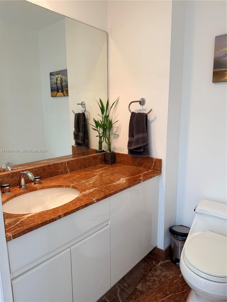 888 Brickell Key Drive, Unit 701 Miami, FL 33131 - Photo 8 of 20 a bathroom with a granite countertop sink and a mirror