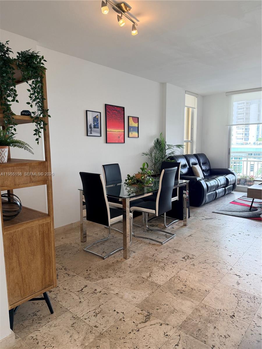 888 Brickell Key Drive, Unit 701 Miami, FL 33131 - Photo 9 of 20 a living room with furniture a air conditioner vent and a window