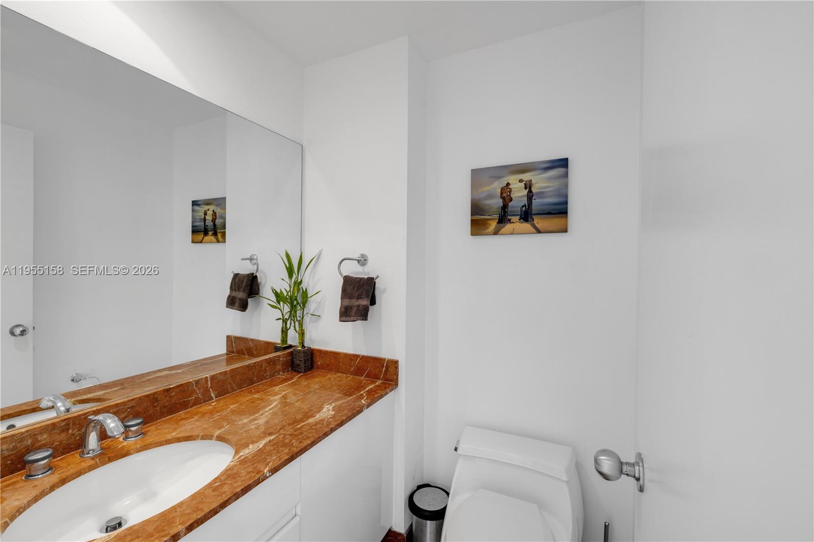 888 Brickell Key Drive, Unit 701 Miami, FL 33131 - Photo 10 of 20 a bathroom with a granite countertop sink and a mirror