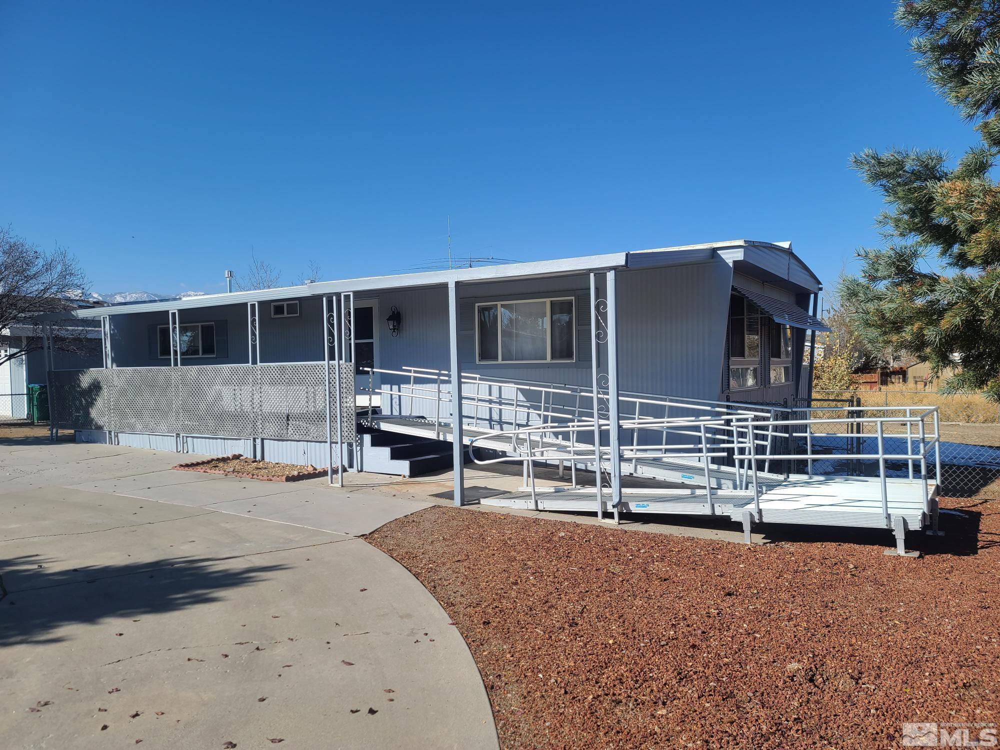 a backyard of a house with barbeque oven and outdoor seating