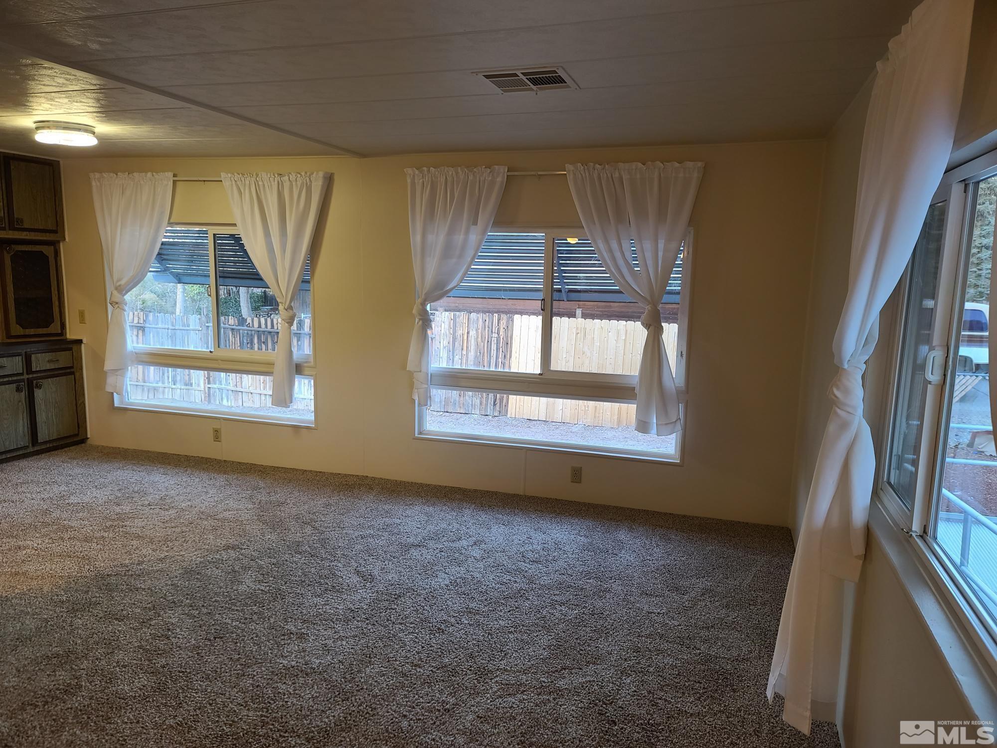 315 Capella Drive Reno, NV 89521 - Photo 12 of 15 a view of an empty room with a fireplace and a window