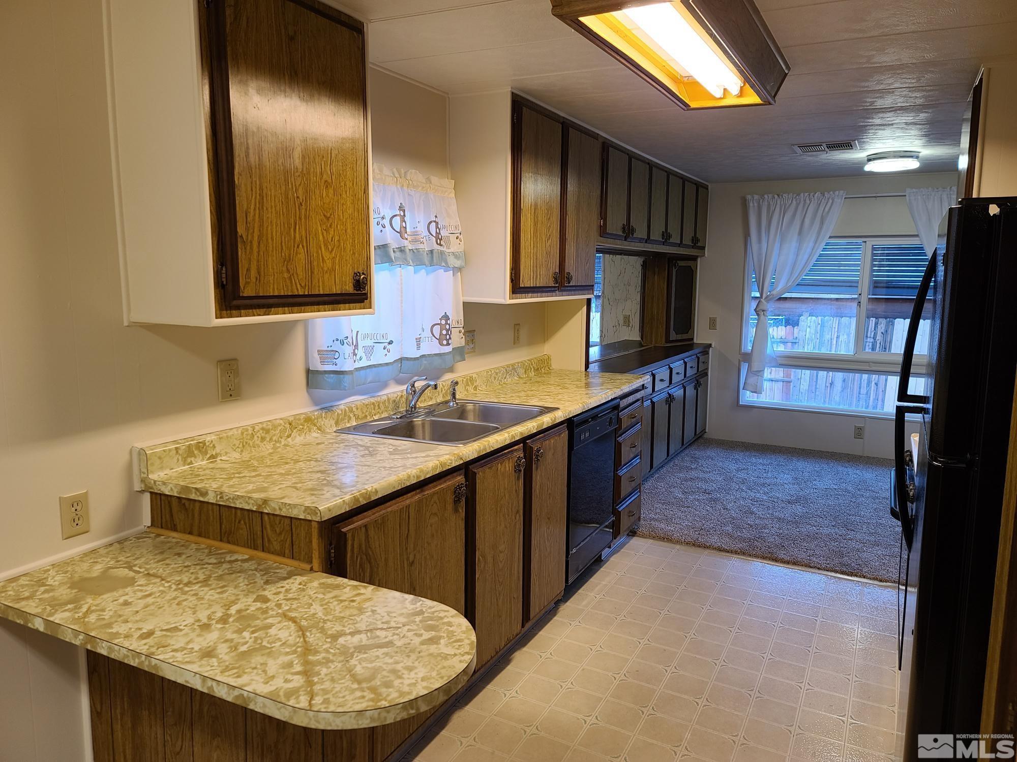 315 Capella Drive Reno, NV 89521 - Photo 7 of 15 a kitchen with stainless steel appliances granite countertop a sink stove and refrigerator