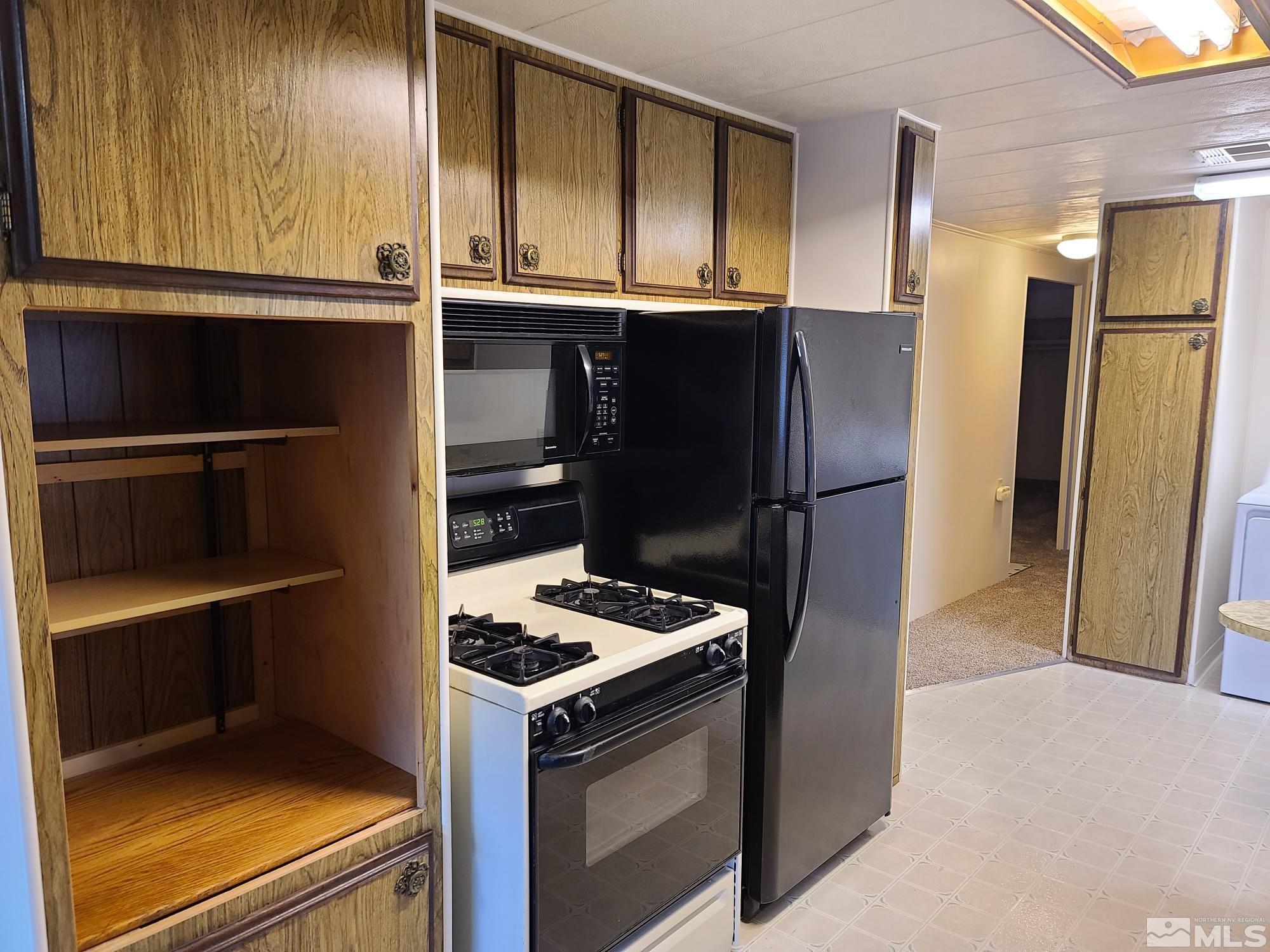 315 Capella Drive Reno, NV 89521 - Photo 8 of 15 a kitchen with a refrigerator and a stove
