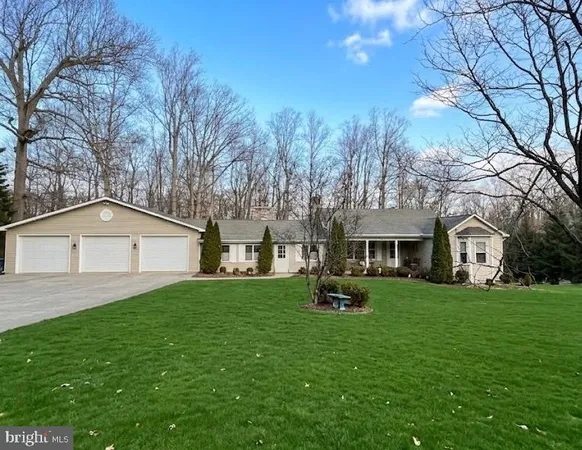a front view of house with yard and trees