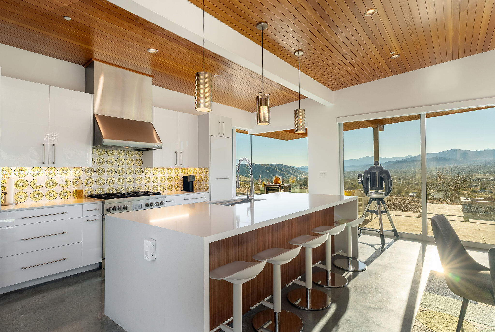 53145 Northridge Road Morongo Valley, CA 92256 - Photo 13 of 48 a kitchen with stainless steel appliances granite countertop a stove a sink dishwasher and a dining table with granite countertops