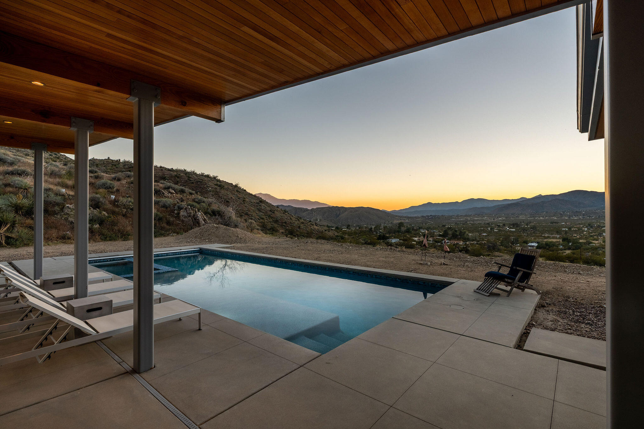53145 Northridge Road Morongo Valley, CA 92256 - Photo 28 of 48 a view of a terrace with a table and chairs