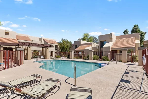 a view of a patio with a table and chairs