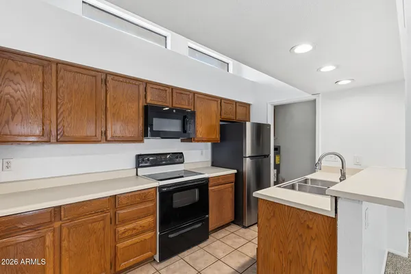 a kitchen with stainless steel appliances a stove a sink and a refrigerator