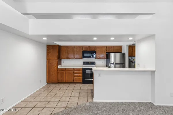 a kitchen with a sink a stove top oven and cabinets