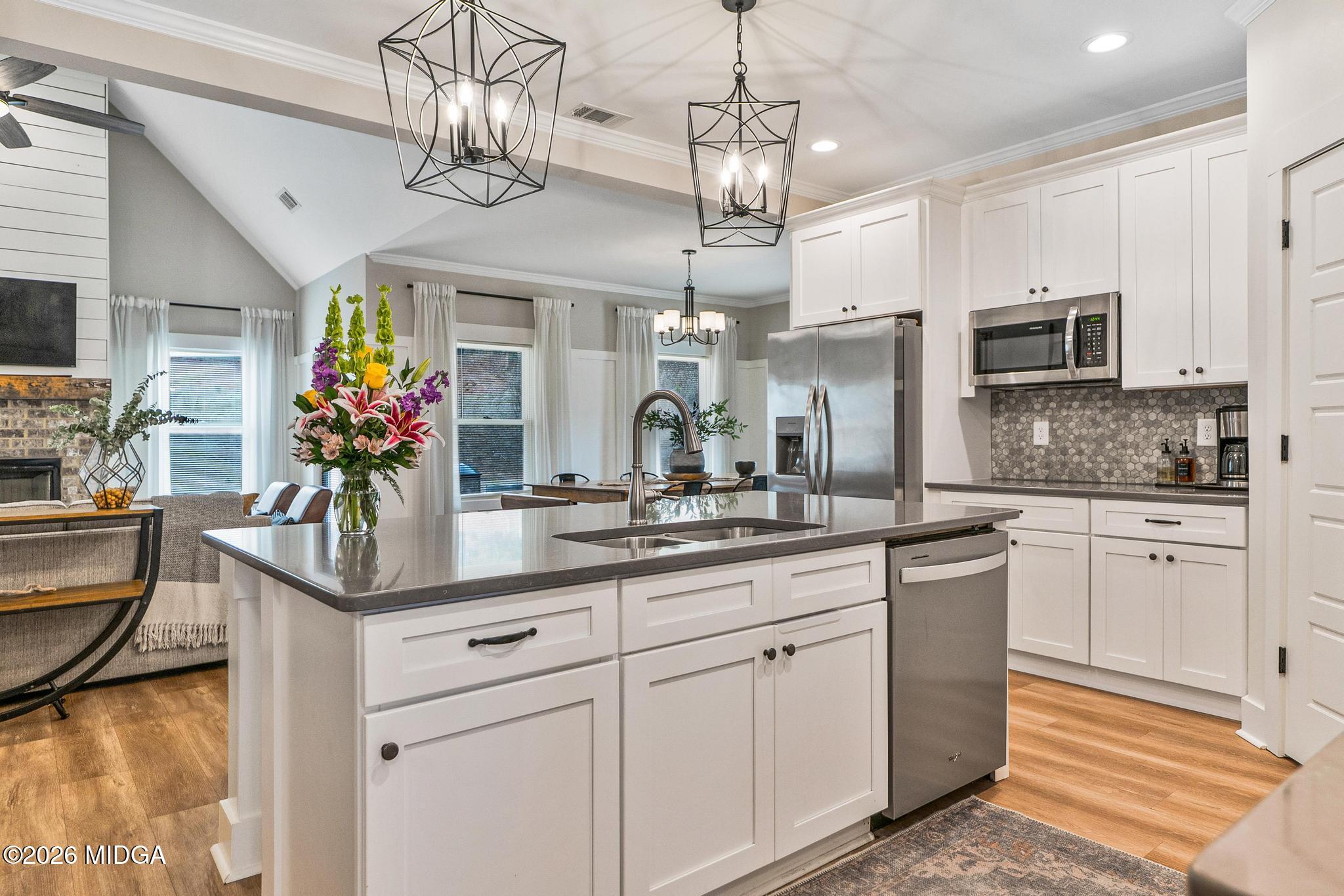 155 Creekside Lane Forsyth, GA 31029 - Photo 11 of 43 a kitchen with cabinets a center island and appliances