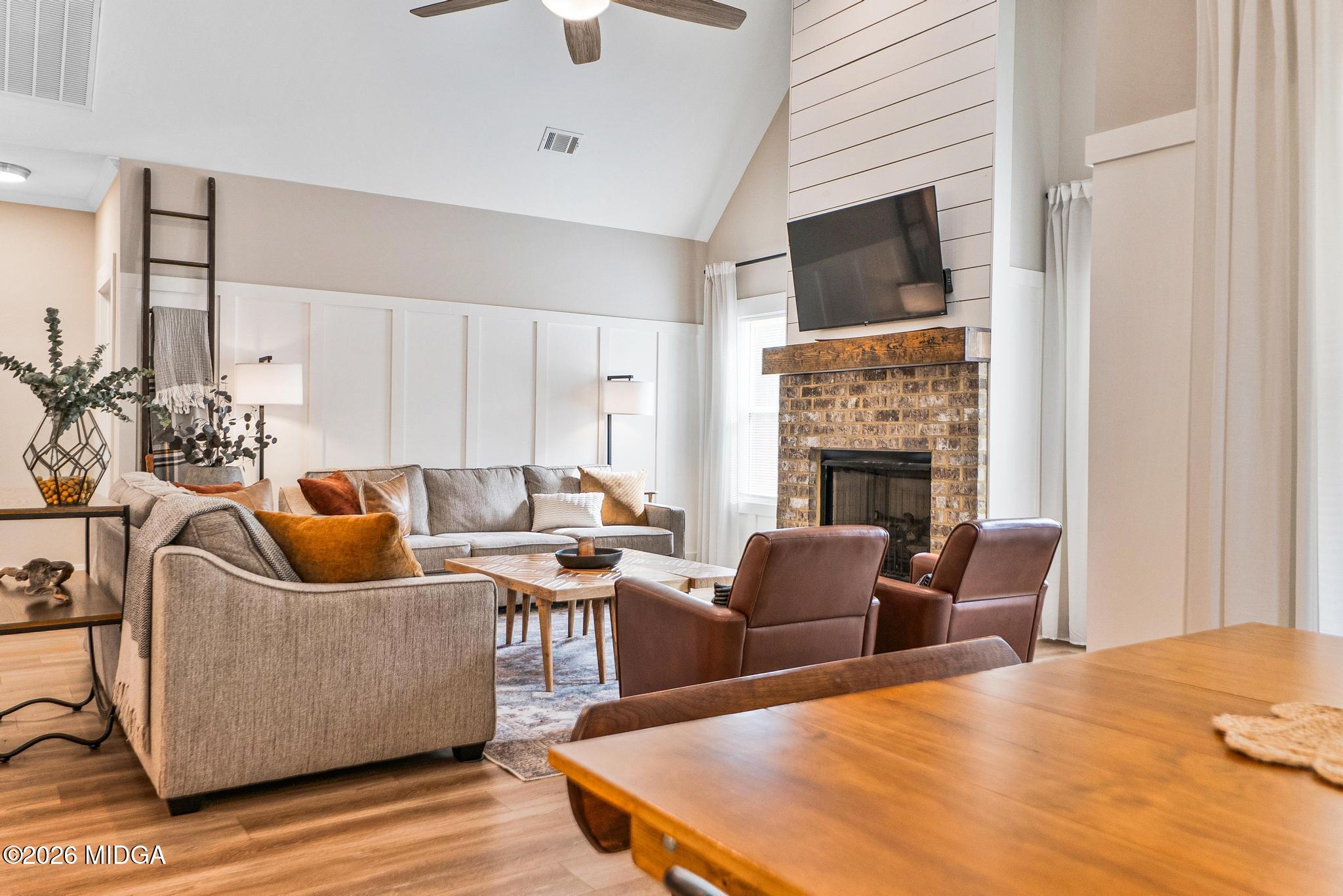 155 Creekside Lane Forsyth, GA 31029 - Photo 12 of 43 a living room with furniture a flat screen tv and a fireplace