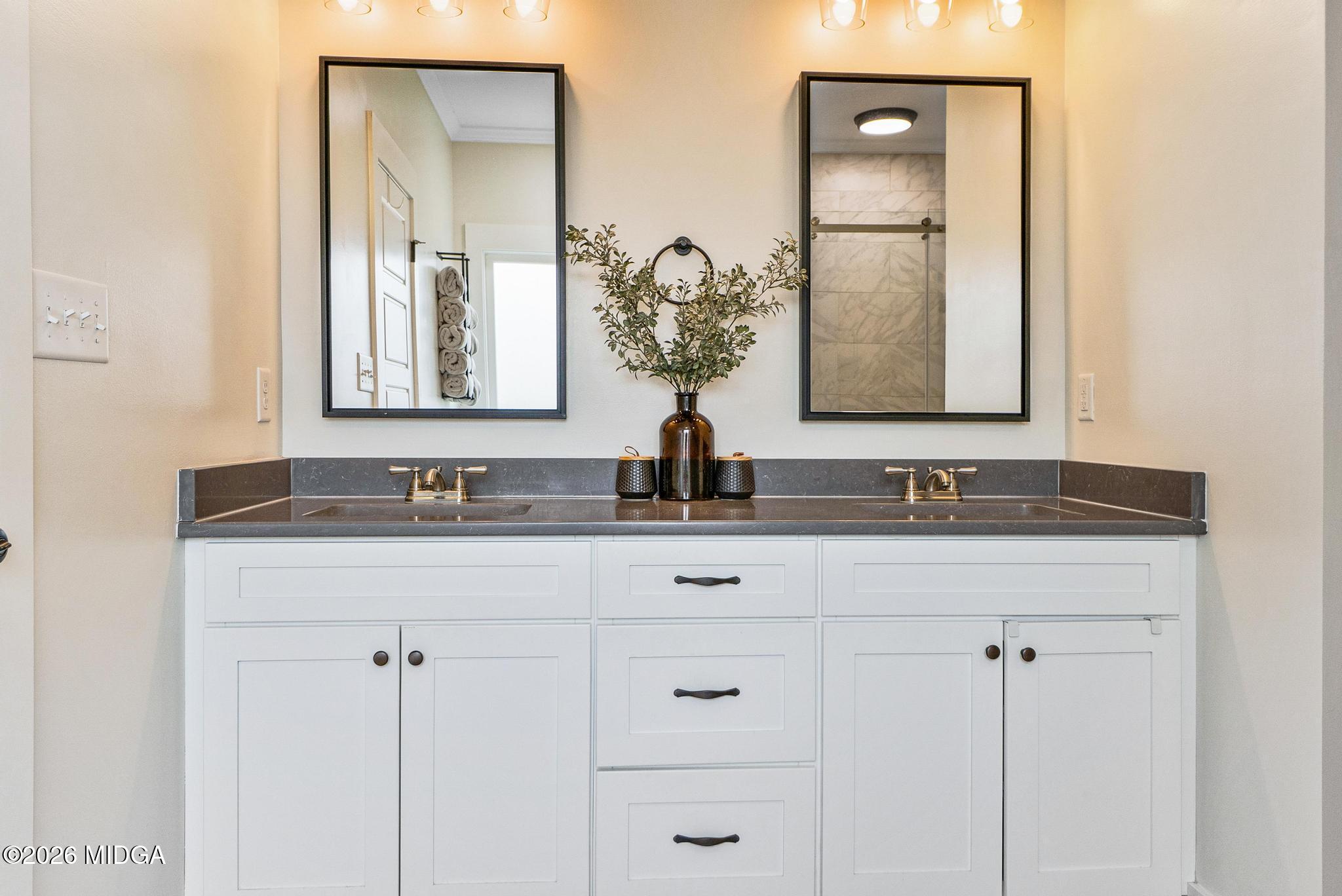 155 Creekside Lane Forsyth, GA 31029 - Photo 20 of 43 a bathroom with double sink and a mirror