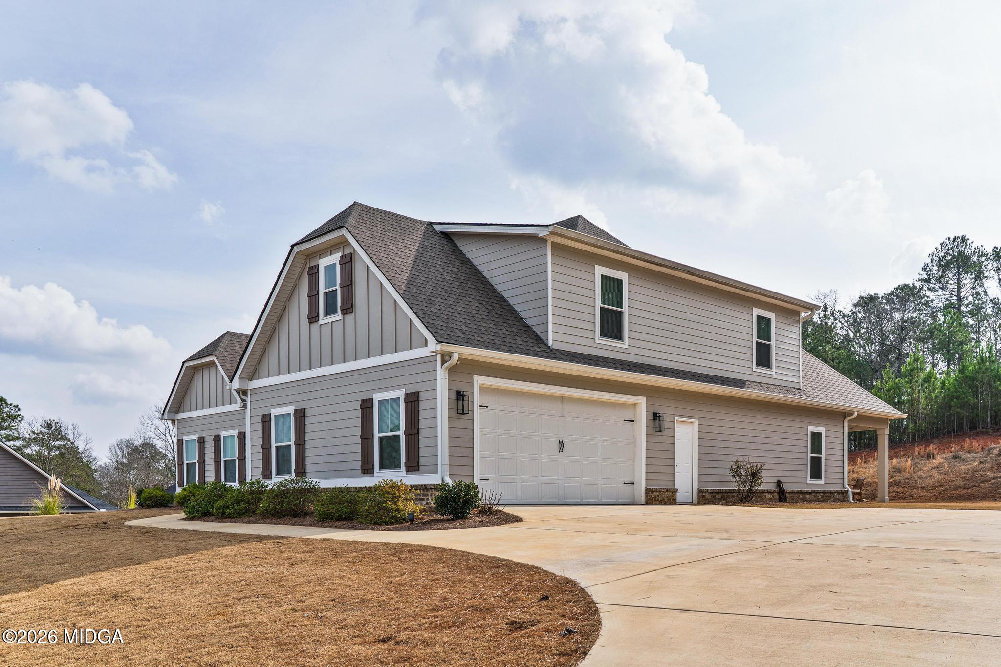 155 Creekside Lane Forsyth, GA 31029 - Photo 2 of 43 a front view of a house with a garden