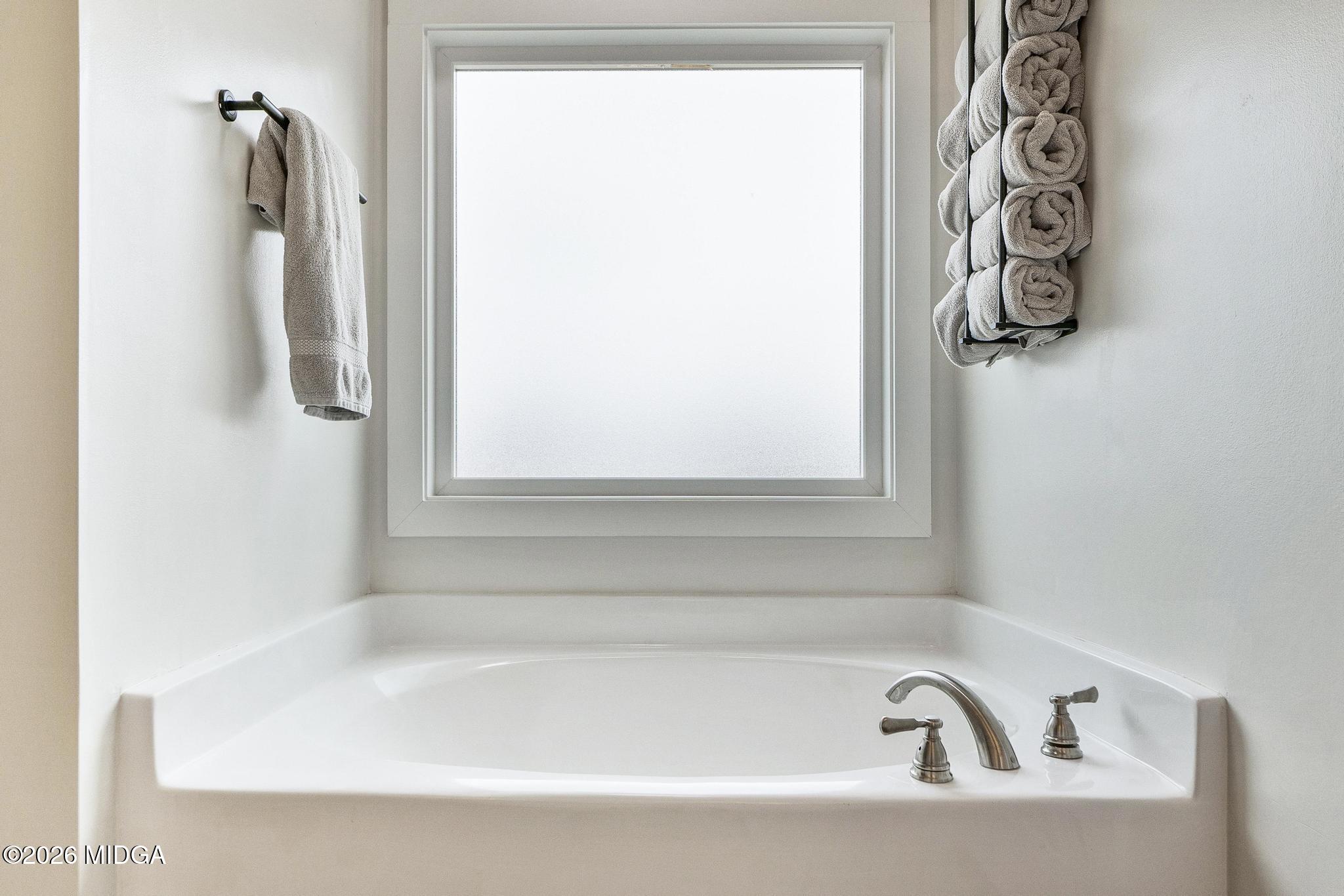 155 Creekside Lane Forsyth, GA 31029 - Photo 21 of 43 a white bath tub sitting next to a window