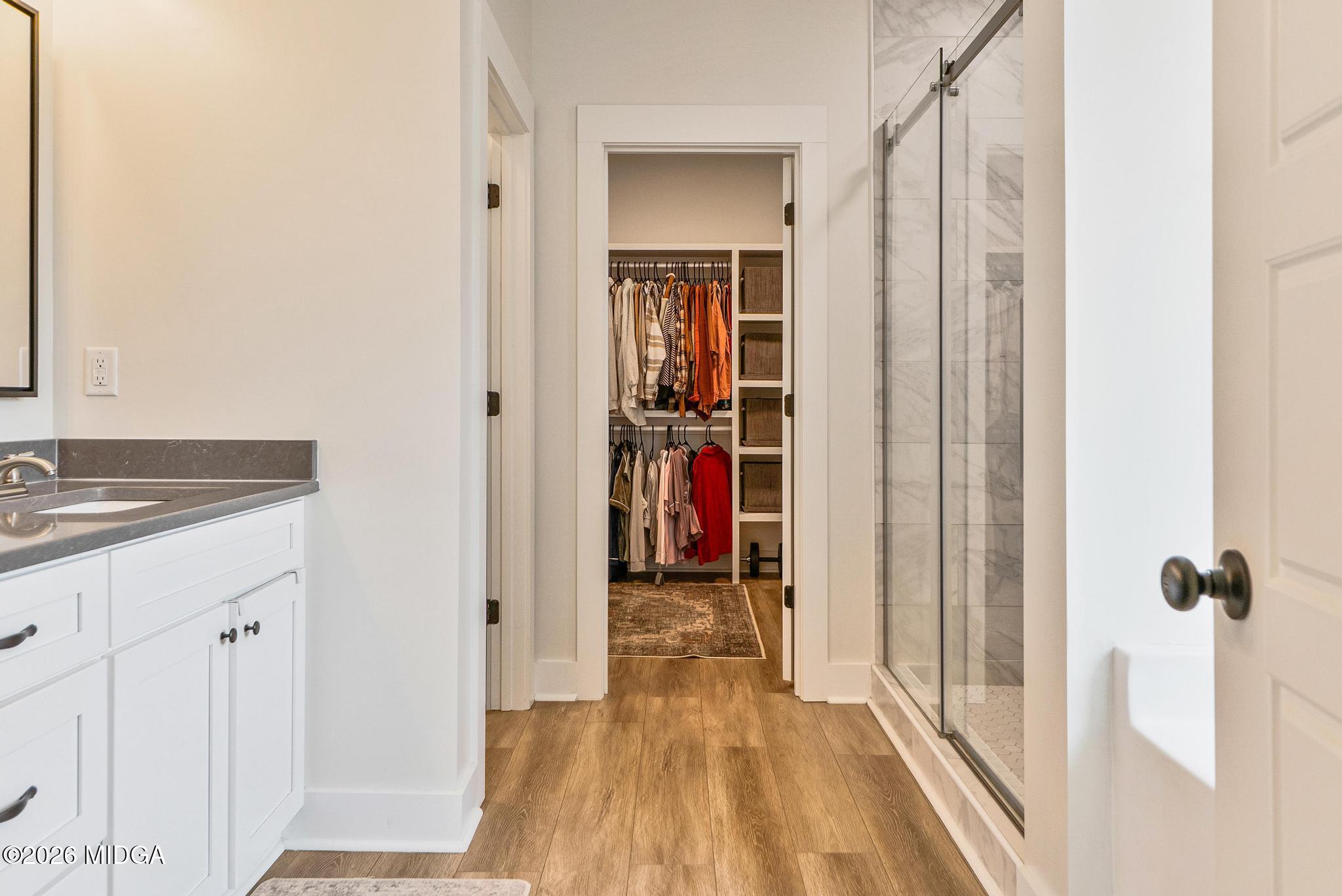 155 Creekside Lane Forsyth, GA 31029 - Photo 22 of 43 a view of a hallway with wooden floor and staircase