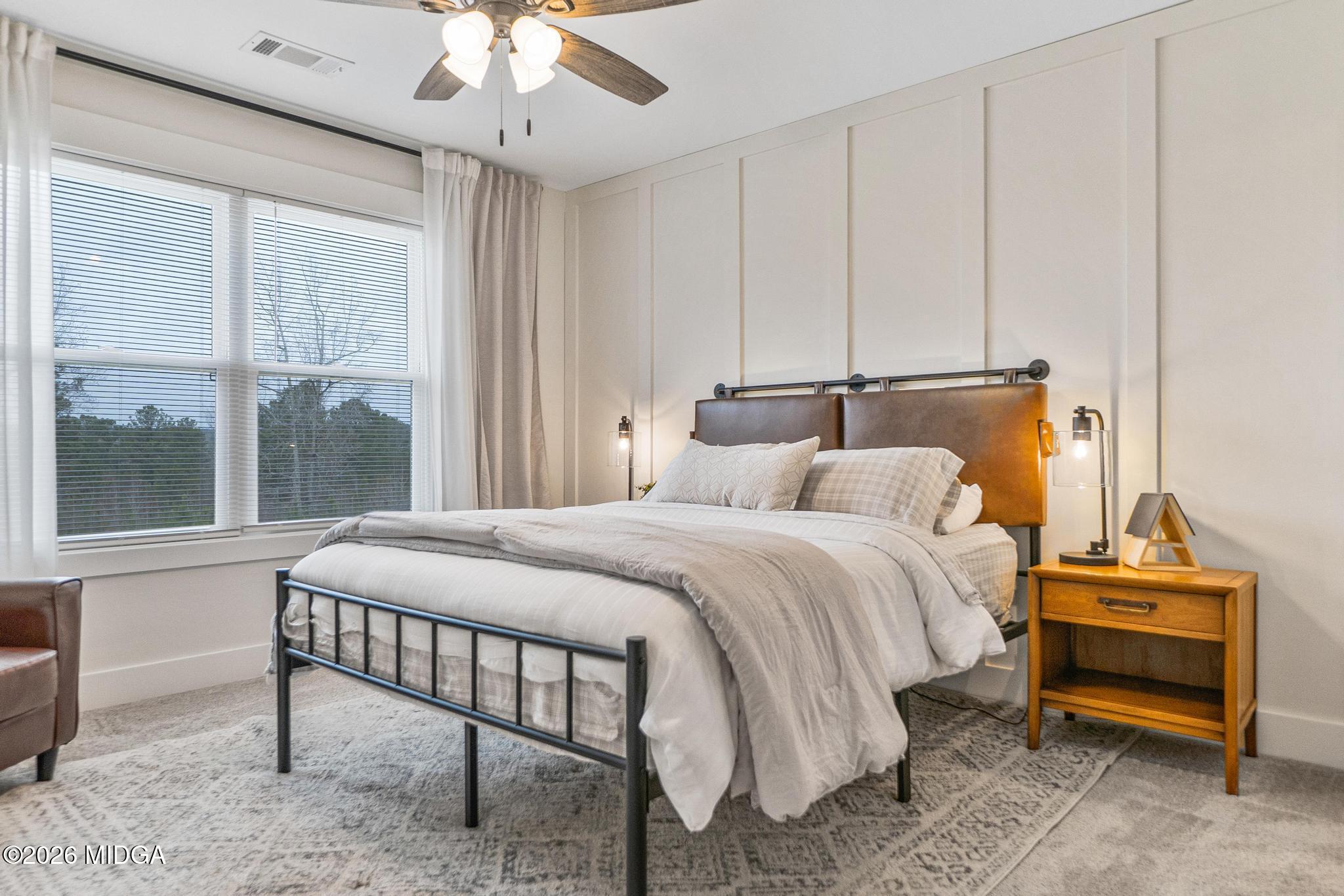 155 Creekside Lane Forsyth, GA 31029 - Photo 25 of 43 a bedroom with a bed and a chandelier