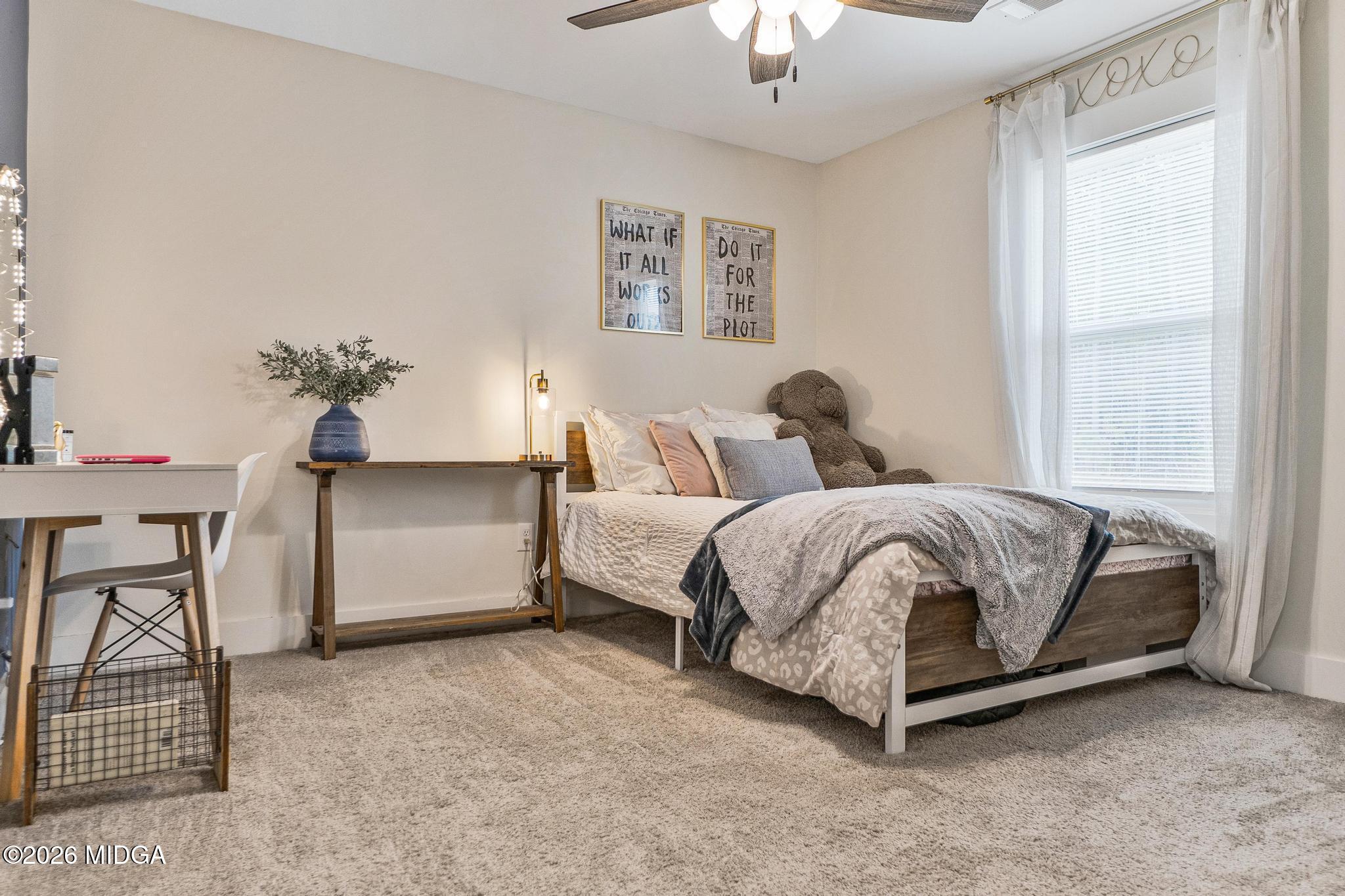 155 Creekside Lane Forsyth, GA 31029 - Photo 28 of 43 a bedroom with a bed dresser and a window