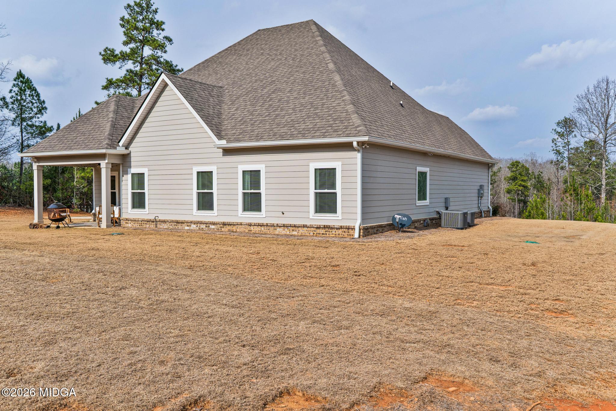 155 Creekside Lane Forsyth, GA 31029 - Photo 42 of 43 a house with yard and tree in front of it