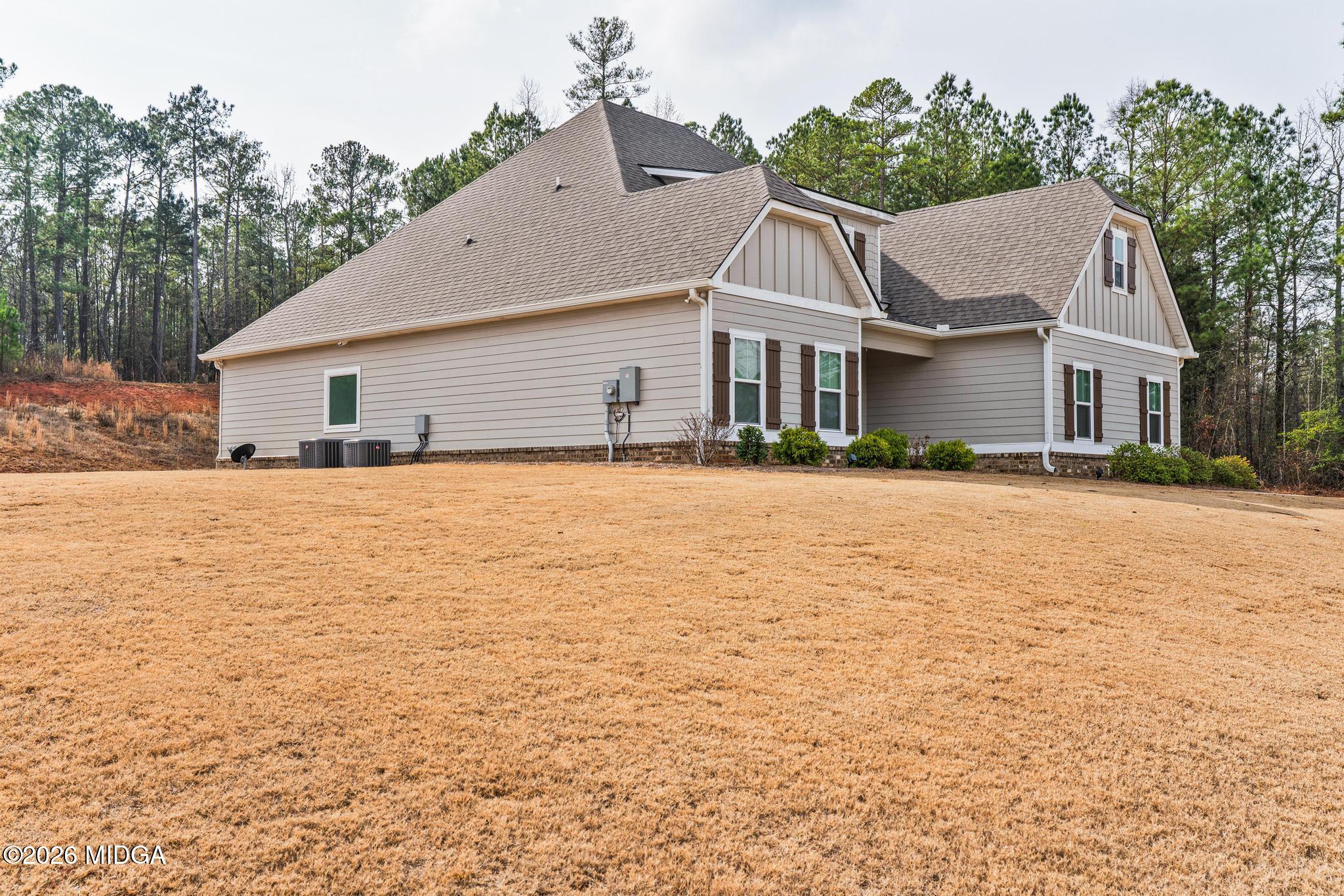 155 Creekside Lane Forsyth, GA 31029 - Photo 43 of 43 a front view of house with yard and trees around