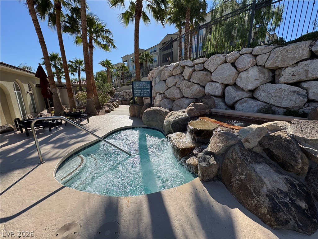 2555 Hampton Road, Unit 4205 Henderson, NV 89052 - Photo 5 of 52 Relax and unwind in this inviting hot tub, complete with a rock waterfall feature.