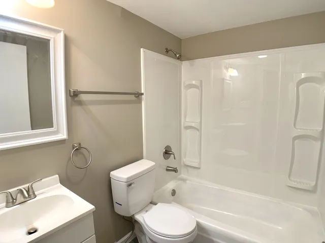 a bathroom with a toilet sink and shower
