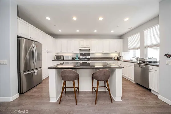 a kitchen with refrigerator cabinets and furniture