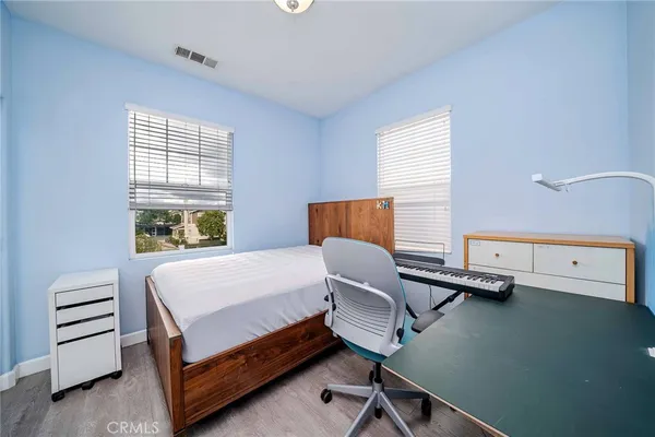 a bedroom with a bed and a desk