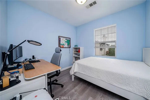 a bedroom with a bed and a desk