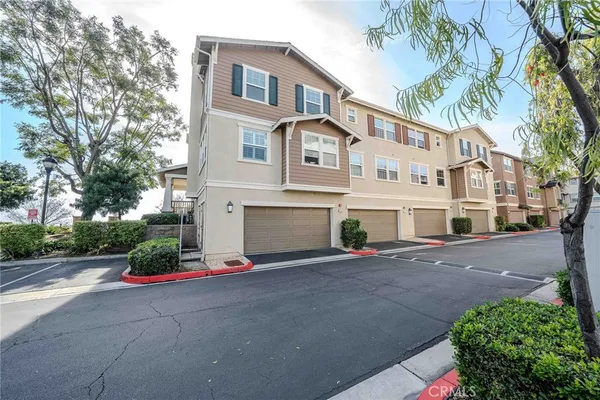 a front view of a house with a yard and a garage