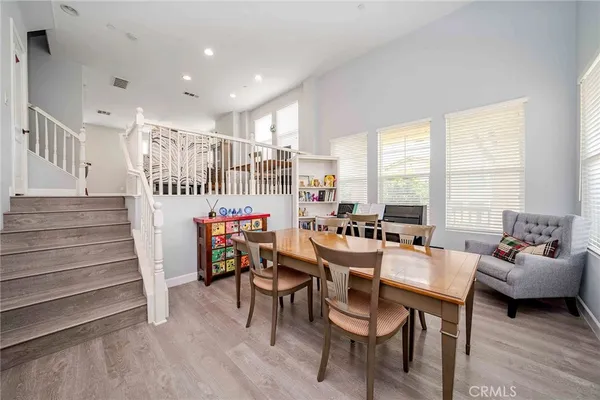 a dining room with furniture and a floor to ceiling window