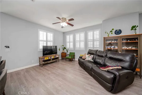 a living room with furniture a window and a flat screen tv