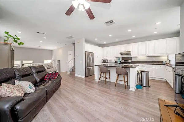 a living room with kitchen island furniture and a kitchen view
