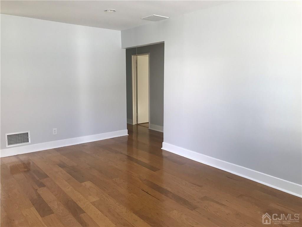 42 Kenmore Road Edison, NJ 08817 - Photo 3 of 14 an empty room with wooden floor and closet