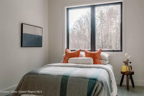 a bedroom with bed and a window