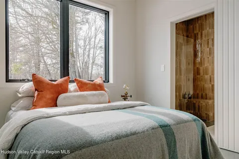 a bedroom with bed and window
