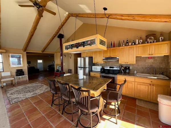 a view of a patio with table and chairs with wooden floor