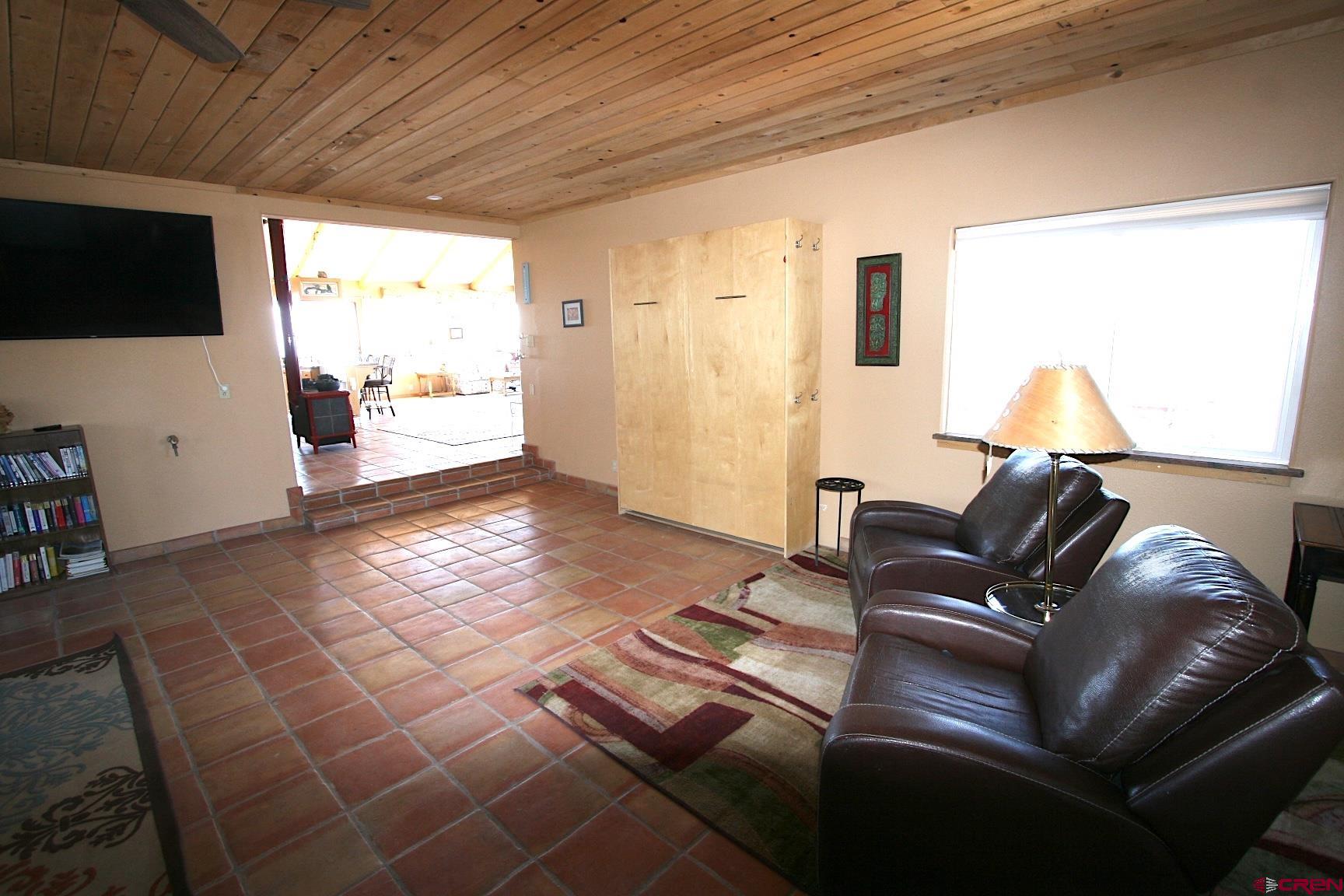 75160 Q72 Road Montrose, CO 81401 - Photo 16 of 33 a living room with furniture and a flat screen tv