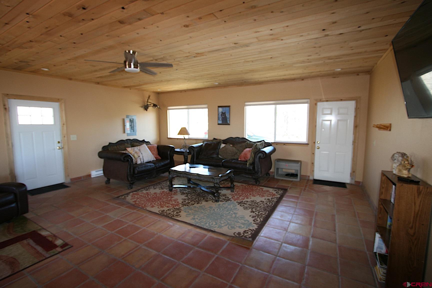 75160 Q72 Road Montrose, CO 81401 - Photo 28 of 33 a living room with furniture a flat screen tv and a window