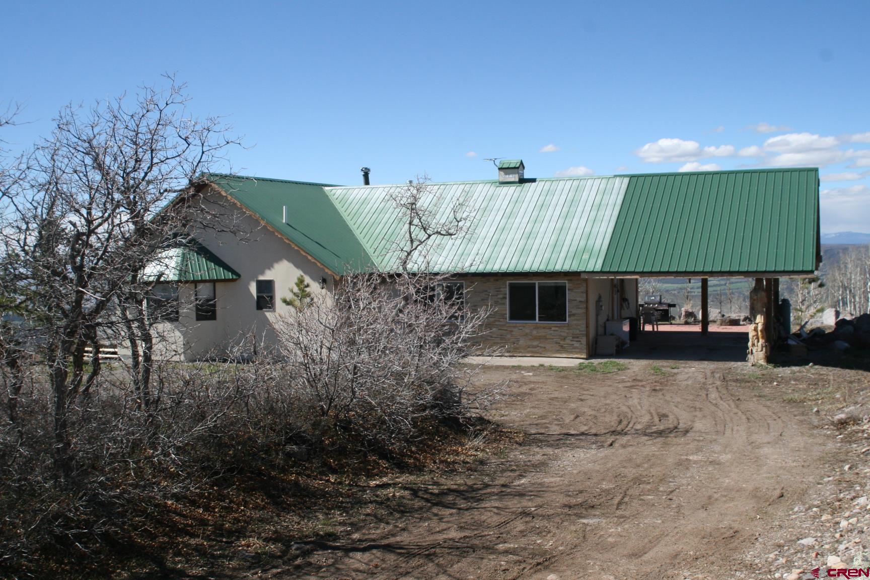 75160 Q72 Road Montrose, CO 81401 - Photo 9 of 33 a view of a house with a yard and sitting area