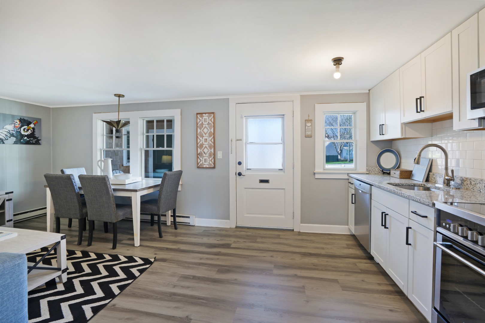 20 Peases Point Way North, Unit 4 Edgartown, MA 02539 - Photo 3 of 11 a view of a dining room with furniture and chandelier