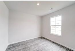 332 Azalea Trail Granbury, TX 76048 - Photo 5 of 8 an empty room with wooden floor and windows