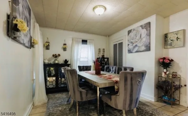 a view of a dining room with furniture and a potted plant