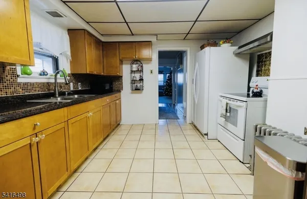 a kitchen with stainless steel appliances granite countertop a refrigerator a sink and dishwasher