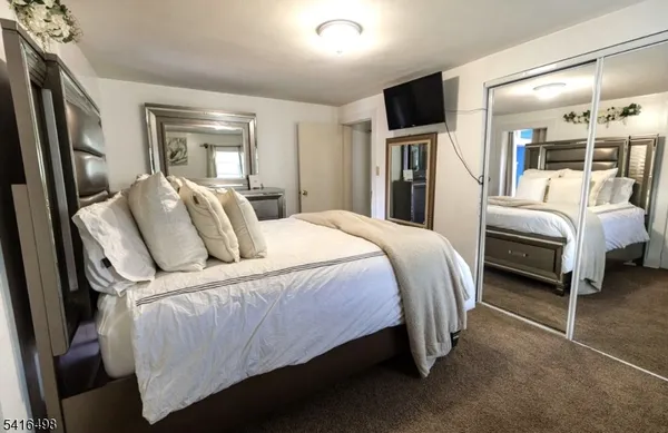 a bed room with a bed and a television