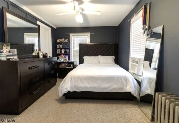 a spacious bedroom with a bed and a chandelier
