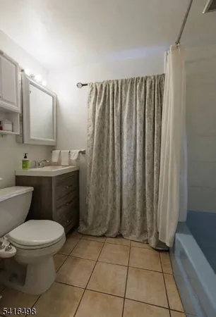 a bathroom with a toilet a sink and shower